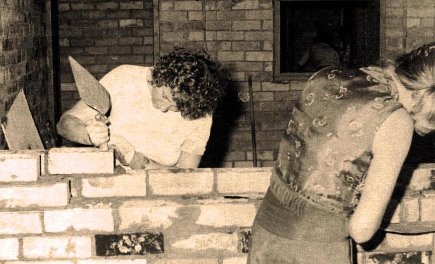 Photo: Gordon Curtis. Taken most likely in November or October 1975 inside the original studios in the basement of U of Q Students Union complex. Margot Foster and Pic (Brenda Mattick) are laying bricks.
